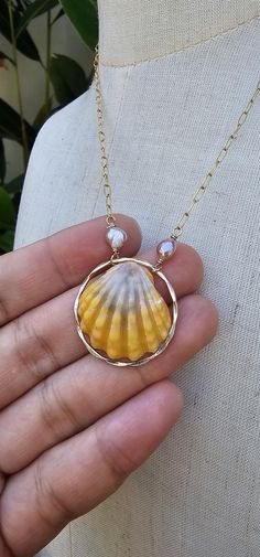 Sunrise Seashell 14K Gold Filled Necklace with Keshi Pearls Chain and Others -14K Gold Filled  Bright Sunrise Seashell  Actual Shell Shown Sunrise Seashell are ONLY found in Hawaii Note: This Jewelry is handmade in Lahaina Hawaii. After the Wildfire, taking over our entire town, burning four of our family houses down to the ground,  with not a single possessions saved,  including a jewelry business...I didn't know how to do it all over again. But thankful from donated materials and Gemstones, I Sunrise Shell Necklace, Gold Shell Necklace Made Of Mother Of Pearl, Gold Shell-shaped Jewelry For Anniversary, Shell-shaped Gold Jewelry For Anniversary, Handmade Gold Shell Pearl Necklace, Gold Shell Jewelry With Pearl Pendant, Gold Mother Of Pearl Shell, Gold Ocean-inspired Shell With Pearl Pendant, Ocean-inspired Gold Shell With Pearl Pendant