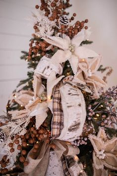 a christmas tree decorated with burlocks and ribbon