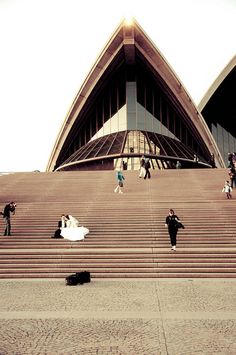 people are walking up and down the stairs in front of an opera performance hall,