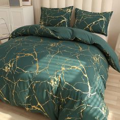 a green and gold comforter set with matching pillows