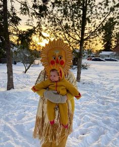 a child in a lion costume standing in the snow