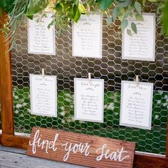 a wooden sign that says find your seat on the side of a fenced in area