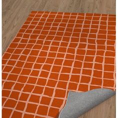 an orange and grey rug on the floor