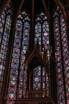 an ornate stained glass window with chandelier