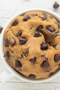 chocolate chip cookie in a white bowl with a spoon