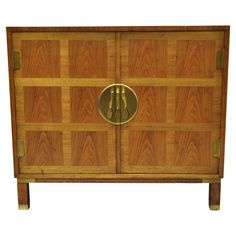 a wooden cabinet with two brass handles