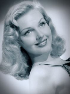 a black and white photo of a woman with blonde hair