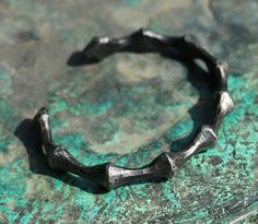 Hand forged bracelet in a bio-industrial style. This one is similar to the limb of a spider. Patina is made from the oak's bark, treated against rust. In a last step of your order send us a circumference of your wrist. Forged Bracelet, Viking Arm Rings, Arm Ring, Nordic Vikings, Real Steel, Forged Steel, Blacksmithing, Hand Forged, Larp