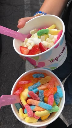 two buckets filled with different colored candies