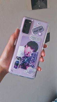 someone is holding up their phone case with an image of the same person on it