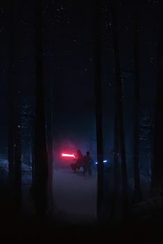 two people sit in the dark with their lights on and one person is holding a light saber