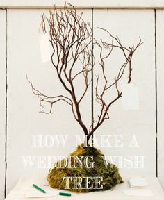 there is a fake tree that has been made into a wedding wish tree for the bride and groom