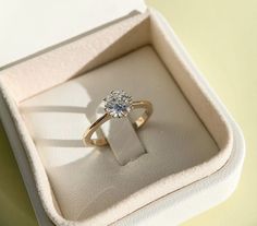 an engagement ring in a box on a table