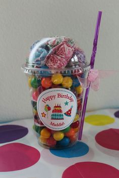 a jar filled with lots of candy on top of a table