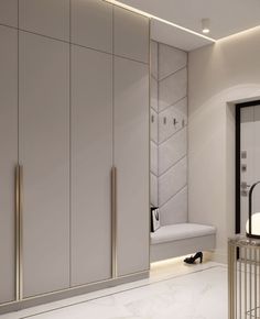 a white and gold bathroom with marble flooring, mirrored walls and cabinetry on the wall