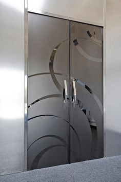 a glass door with an abstract design on it