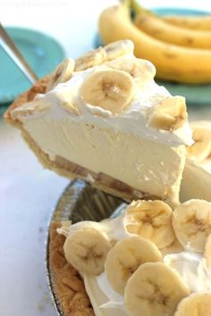 a slice of pie with bananas on top is being lifted from the pie plate by a fork