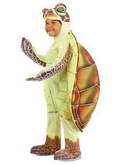 a man in a turtle costume is standing with his hands out to the side and smiling