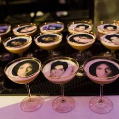 several martinis with pictures of people on them are lined up next to each other