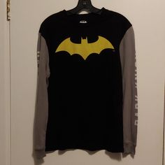 A Long Sleeve Black Shirt W/ Grey Sleeves And A Yellow Batman Logo In The Middle. Never Worn, Offers Welcome. Bundle With Two Other Listings With "3/$20" And Get All Three Items For $20! Yellow Long Sleeve Tops For Streetwear, Yellow Crew Neck Shirt For Fall, Long Sleeve Yellow Shirt For Streetwear, Yellow Long Sleeve Shirt For Streetwear, Fall Yellow Crew Neck Shirt, Yellow Long Sleeve Streetwear Shirt, Yellow Long Sleeve Cotton Top, Yellow Cotton Long Sleeve Tops, Yellow Long Sleeve Top With Graphic Print