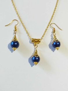 Cobalt blue pearl gold jewelry set Royal blue pearl gold tone jewelry set bohemian set wedding jewelry Victorian jewelry set Boho set Bohemian Cobalt blue glass pearl and gold-tone Victorian filigree jewelry set earrings and necklace . Gold-tone beautiful Boho jewelry set earrings and necklace . Bohemian jewelry set . Victorian style gold tone and fine Royal blue glass pearl dangle earrings and necklace . Chic gold toned pearls jewelry set . Romantic blue pearls jewelry set . Brides or bridesmaids jewelry set . Absolutely beautiful jewelry set ! FREE SHIPPING  Material : blue glass pearls, gold tone metal ornaments beads, steel , gold-tone metal chain. Length of earrings with hooks : 1.80 inches ( 4.5 cm) Length of chain necklace - 18.20 inches (46 cm.) If you have any question, please con Blue Bohemian Pearl Necklace For Gift, Blue Bohemian Jewelry With Pearl Charm, Bohemian Blue Jewelry With Pearl Charm, Gold Plated Pearl Drop Jewelry Sets For Gifts, Blue Round Jewelry With Pearl Charm, Blue Round Pearl Charm Jewelry, Handmade Gold Pearl Jewelry Sets, Handmade Gold Jewelry Sets With Pearls, Blue Pearl Jewelry For Party