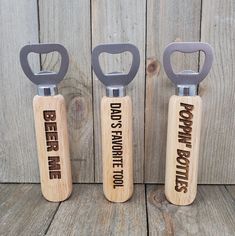 three bottle openers with the words beer on them