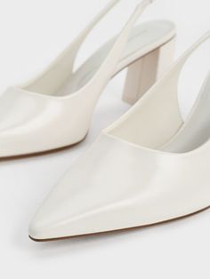 Presenting slingback pumps in match-all white. These gems are set to be a closet staple as they will complement your workwear ensembles with remarkable ease. Set on trapeze block heels, they strike the balance between form and function. Plus, the sharp pointed toes offer a leg-lengthening effect. The lightly elasticated slingback straps guarantee a snug fit. White T Strap Heels, Wedding Shoes Slingback, T Strap Heels, Size Chart For Kids, Bowling Bags, Charles Keith, Faux Leather Heels, White Pumps, Orange Bag