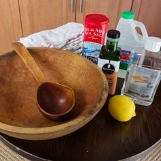 a wooden bowl and spoon on a table with ingredients to make an apple cider