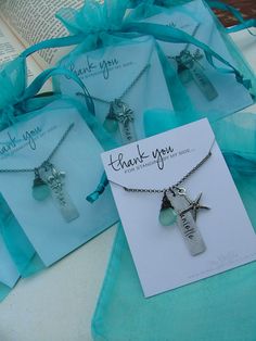 three cross necklaces with thank you written on the front and back of each one