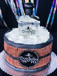 there is a cake made to look like a barrel with ice in it and a bottle on top