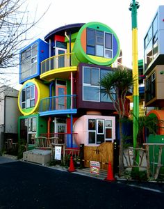 a multi - colored building with many windows and balconies on the top floor