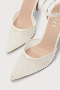 a pair of white high heels with straps