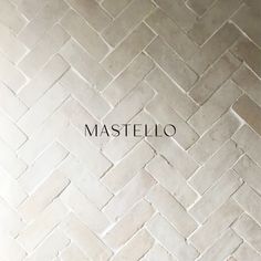 the words master written in front of a white brick wall with an image of a herringbone pattern