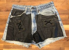 Vintage LEVI STRAUSS & CO 80's shorts with black leather sewn over the jean material.  Excellent condition and look super hot on.  28 Waist Black Leather Edgy Shorts, Edgy Fitted Leather Shorts, Fitted Edgy Leather Shorts, Retro Black Spring Shorts, Edgy Black Leather Shorts, Edgy Leather Shorts, Edgy Leather Shorts For Spring, Black Vintage Fitted Shorts, Edgy Leather Bottoms For Summer