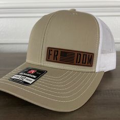 Freedom Flag Patriotic Patch Hat Khaki Specifications: 🧢 Richardson original 112 trucker; adjustable for the perfect fit 🎩 60/40 cotton/polyester blend for comfort 📏 One size fits most 🏷️ Expertly laser engraved leatherette patch design 📦 Ships in 2 to 3 business days from our Orlando Studio Care Instructions: 🚫 Do not wash; spot clean only Please Note: 🌈 Colors may vary from photos based on your viewing screen. This funny hat is a unique and entertaining gift for fathers, embracing their Laser Hat Patches, Leather Patch Ideas, Leather Patch Hats, Leather Patch Hat Ideas, Hats With Patches, Orlando Studios, Laser Crafts, Glowforge Projects, Crafting Corner