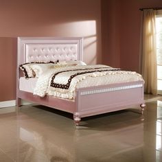 a bedroom with pink walls and a white bed in the middle, along with beige carpeting