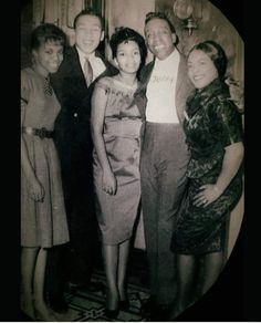 an old black and white photo of four people