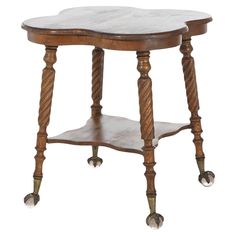 an old wooden table with wheels on the legs and a marble top, isolated against a white background