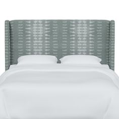 an upholstered bed with white linens and green headboard on a white background