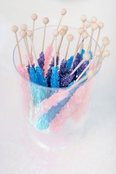 there are many toothpicks in the cup with some candy on top of it