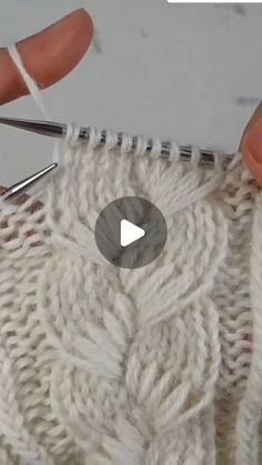 someone is crocheting the stitches on their sweater