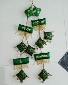 green and gold ornaments are hanging on the wall