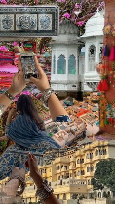 two women are taking pictures with their cell phones in front of the cityscape