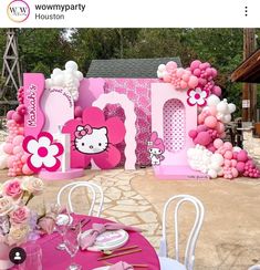 a hello kitty themed birthday party with balloons and flowers on the table for an event