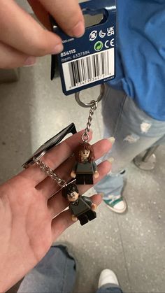 someone is holding onto some lego key chains