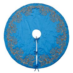 a blue and silver round table cover with floral designs on the edges, sitting on a white surface