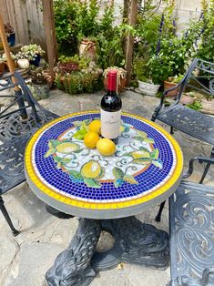 a bottle of wine sitting on top of a table next to some chairs and tables