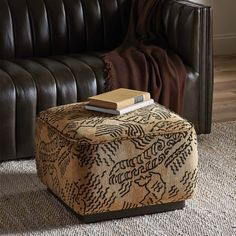 an ottoman with a book on top of it