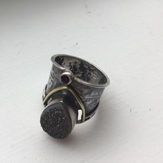 Artisan Crafted Grey Druzy, Sterling Silver And 14k Gold Ring Is Nwot! In Brand New Unworn Condition. Artisan Crafted So Didn’t Come With Tags. Sterling Silver Etched Cigar Band With Tear Drop Shaped Grey Druzy And 14k Gold Accents. Tiny Round Garnet Below The Druzy. It's So Hard To Highlight The Sparkle Of The Grey Druzy In These Photos; Didn't Help That It Was A Cloudy Old Day. Size 6: Just Under One Inch Wide At Its Widest Point; Band Is Thicker In Front Than The Back. Retailed For $136. Hand Forged Wide Band Jewelry Gift, Unique Hand Forged Wide Band Jewelry, Heirloom Sterling Silver Hand Cast Jewelry, Heirloom Hand Cast Sterling Silver Jewelry, Hand Cast Sterling Silver Wide Band Jewelry, Artisan Wide Band Jewelry As Gift, Artisan Hand Forged Wide Band Jewelry, Artisan Hand Cast Jewelry For Anniversary, Unique Wide Band Jewelry For Anniversary