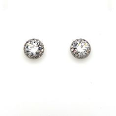 These timeless stud earrings are the perfect way to add a dainty and clean detail to your bridal look. Finished with a delicate halo, this pair comes in silver or gold. -AAA Cubic Zirconia -Approximately 0.5in across (1.3cm) -Rhodium or gold plated non-tarnish finish for brilliance Classic Bridal Earrings With Halo Setting In Diamond White, White Gold Bridal Earrings With Halo, White Bridal Earrings With Halo Setting, White Gold Round Bridal Earrings With Halo, White Round Cut Halo Bridal Earrings, Classic Halo Bridal Earrings For Formal Occasions, Classic Formal Bridal Earrings With Halo, White Halo Setting Round Cut Bridal Earrings, Diamond Halo Cluster Earrings For Wedding